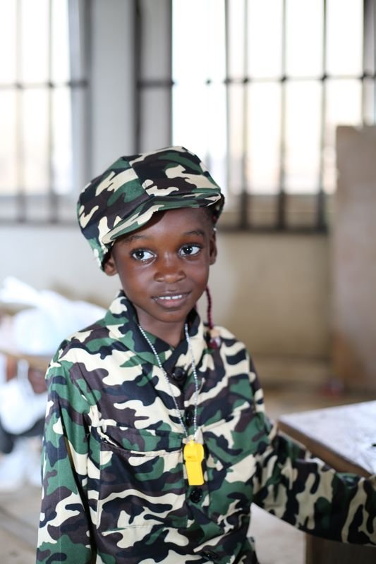 A pupil in a camouflage soldier cap on Career Day