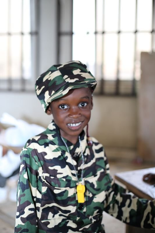 A smiling pupil in a soldier costume